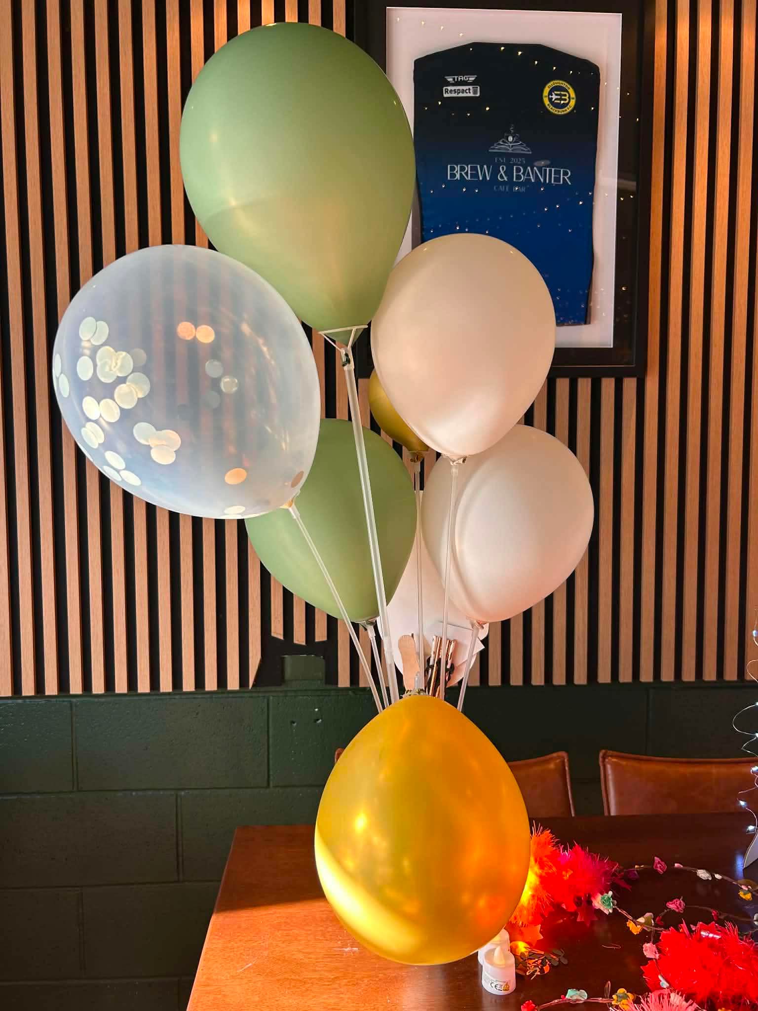 Gold, green and white balloon decorations at Emily's hen party at Brew and Banter Brough